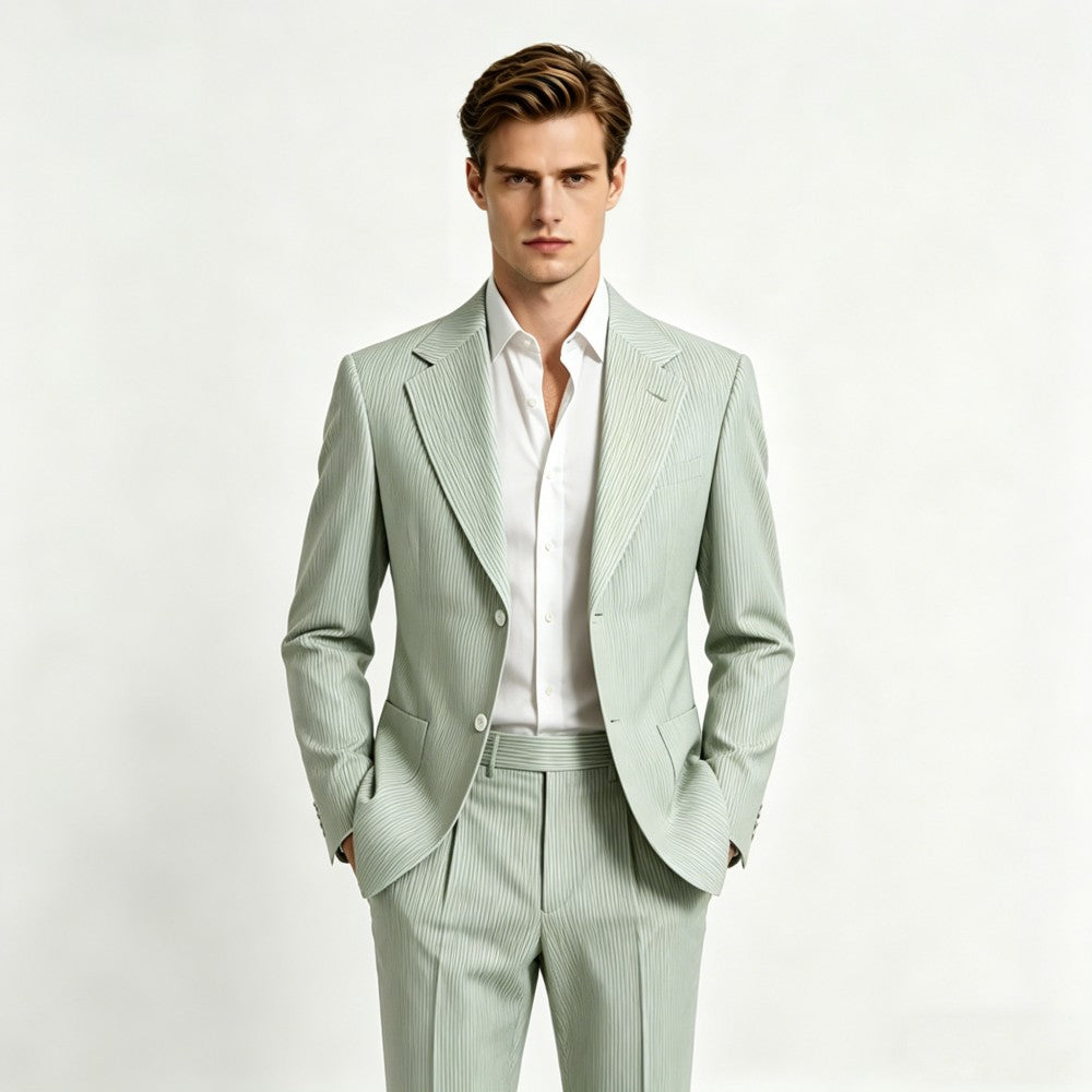 Man wearing a light green suit with a white shirt on a white background