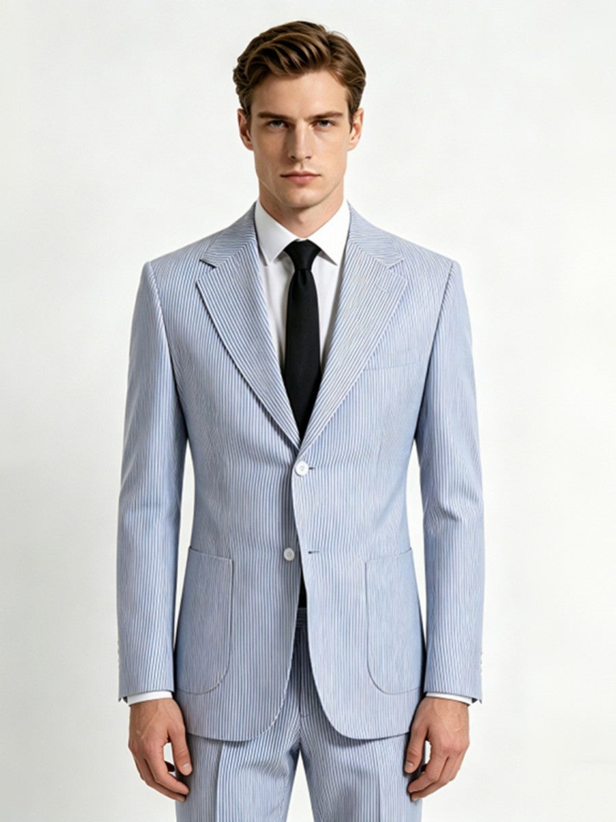 Man wearing a light blue striped suit with a black tie on a white background